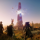 Colonial warriors stand in a field across from a tower that's exploding into magic crystals.